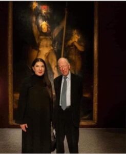 Marina Abramovic And Jacob Rothschild Posing In Front Of “Satan Summoning His Legions” Painting
