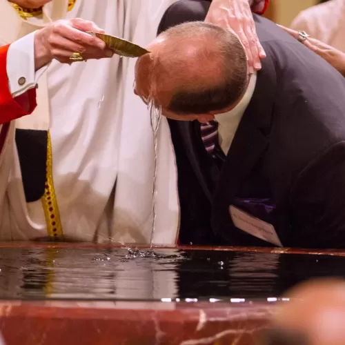 A file photo shows a catechumen being baptized during the Easter Vigil. Over 12,000 people, adults and adolescents, were baptized in France during the Easter Vigil March 30, 2024, a record number in the country which experiences an accelerated de-Christianization. (OSV News photo/James Ramos, Texas Catholic Herald)