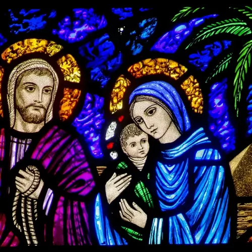 A detail of a stained-glass window from St. Edward's Church in Seattle shows Jesus, Mary and Joseph on their flight into Egypt. The feast of the Nativity of Christ, a holy day of obligation, is celebrated Dec. 25. The feast of the Holy Family is marked Dec. 29. (CNS/Crosiers) (Nov. 19, 2013)